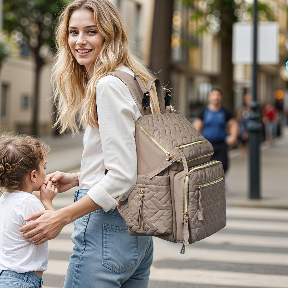 Omanmoli diaper bag backpack side pocket area for quick-access bottle or wipes.