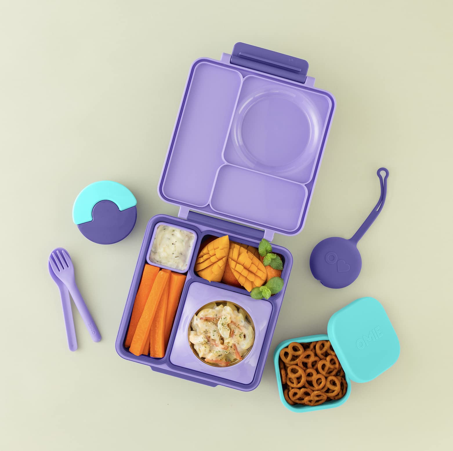 OmieBox silicone snack container inside compartment showing compact packing