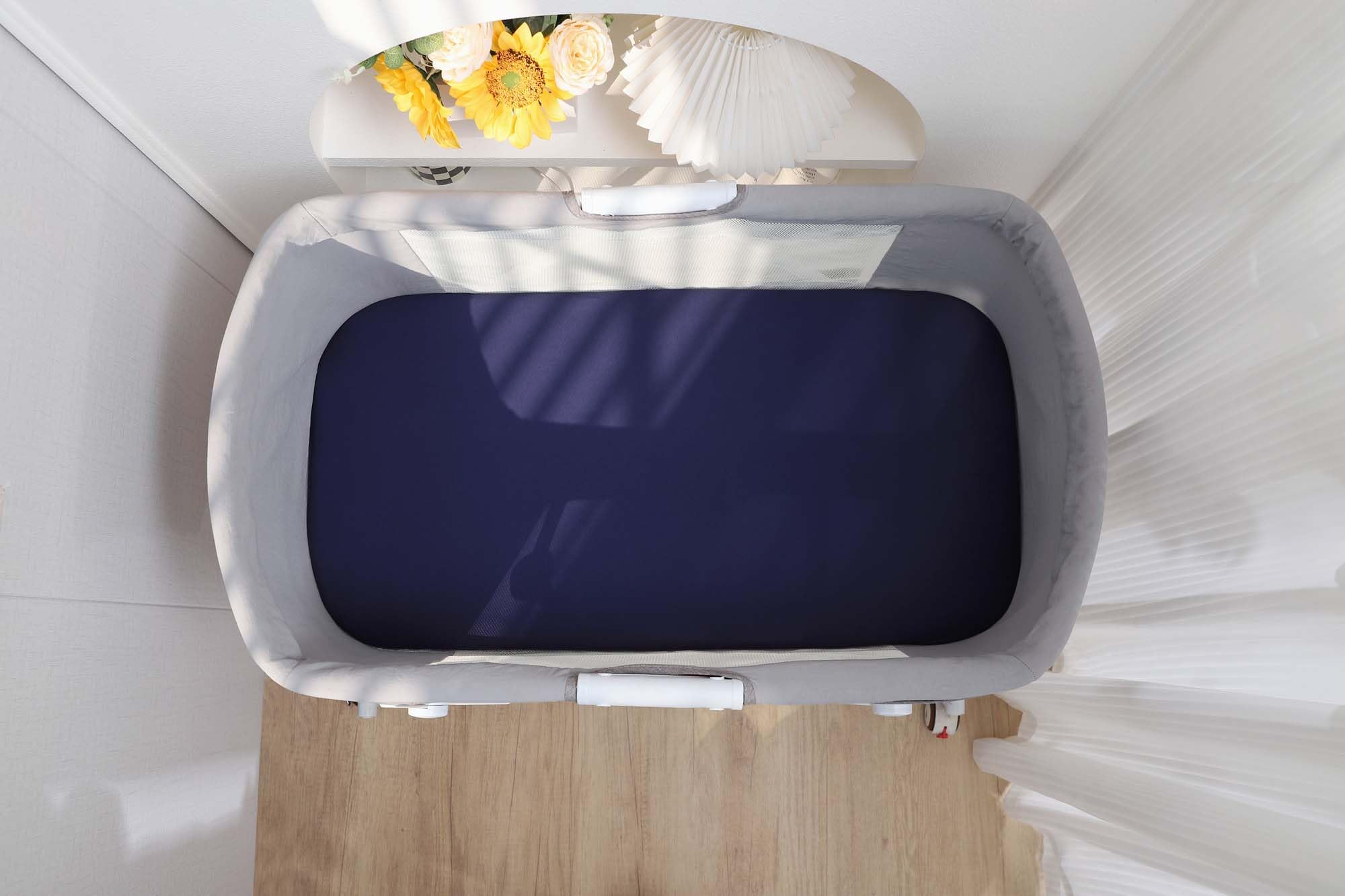 Onacosht fog-grey fabric closeup emphasizes neutral tone for unisex nurseries.