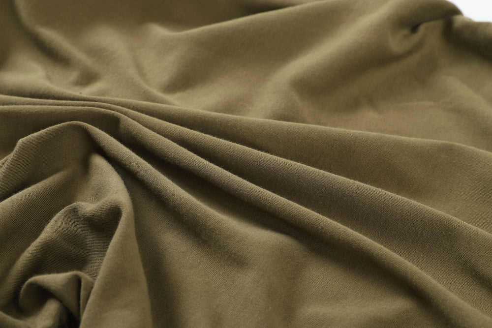 Onacosht bassinet sheets close-up highlights the 360° elastic band securing the sheet