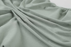 Onacosht bassinet sheets on mattress demonstrating universal fit and Halo compatibility