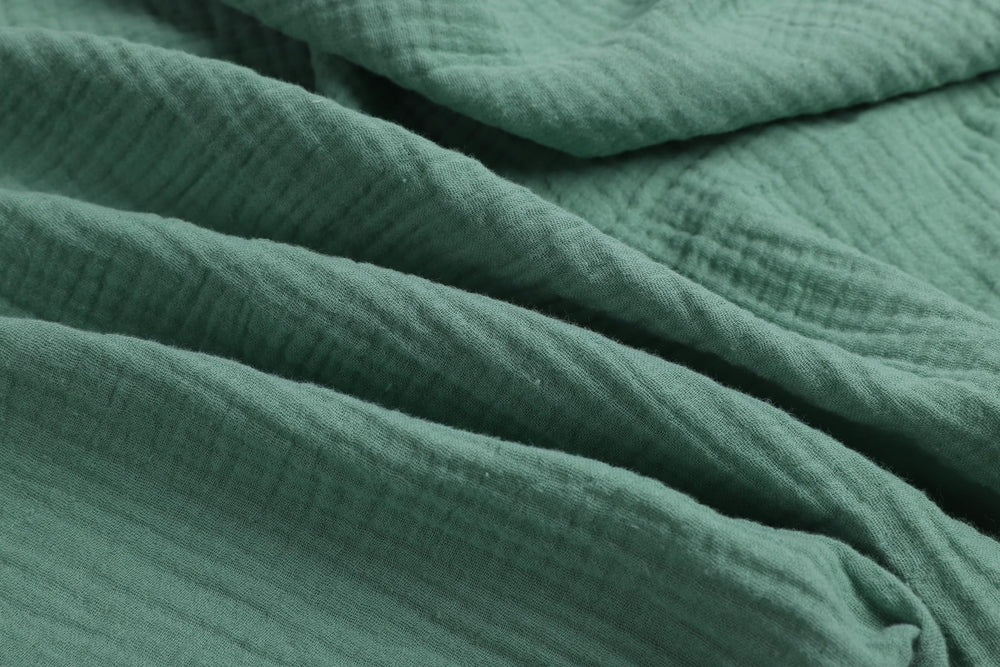 Onacosht muslin bassinet sheets closeup reveals gentle cotton texture for delicate skin.