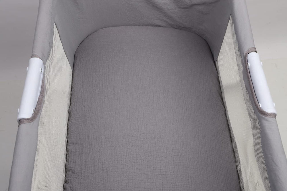 Onacosht muslin sheets displayed on bassinet illustrate easy care and quick changes.