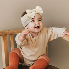 ONENINEDREAM soft fabric baby headband closeup highlights a gentle feel against delicate skin.