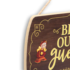 Open Road Brands Be Our Guest sign with yellow text on a wood grain backdrop