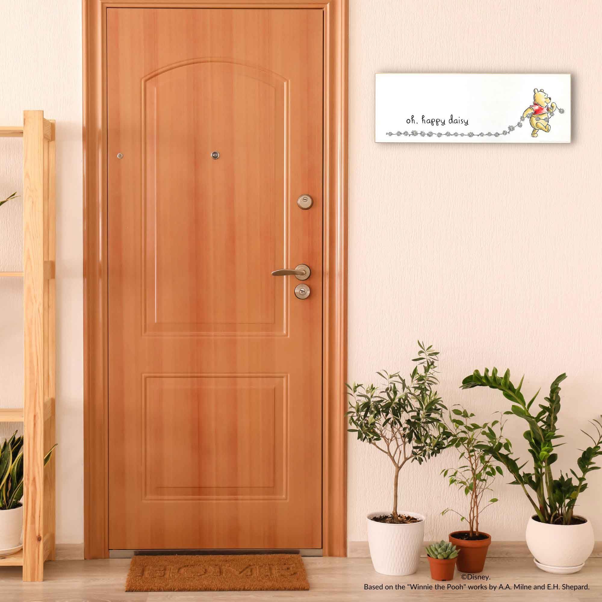 Open Road Brands Pooh 24.5-inch wall art adds a bold nursery or bedroom accent