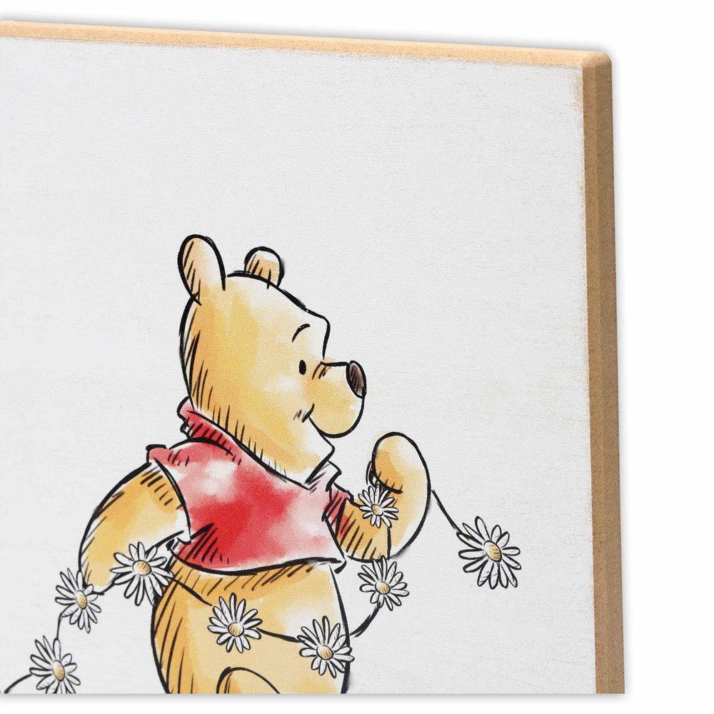 Open Road Brands Winnie the Pooh wall art in a kid's room for a cozy focal point