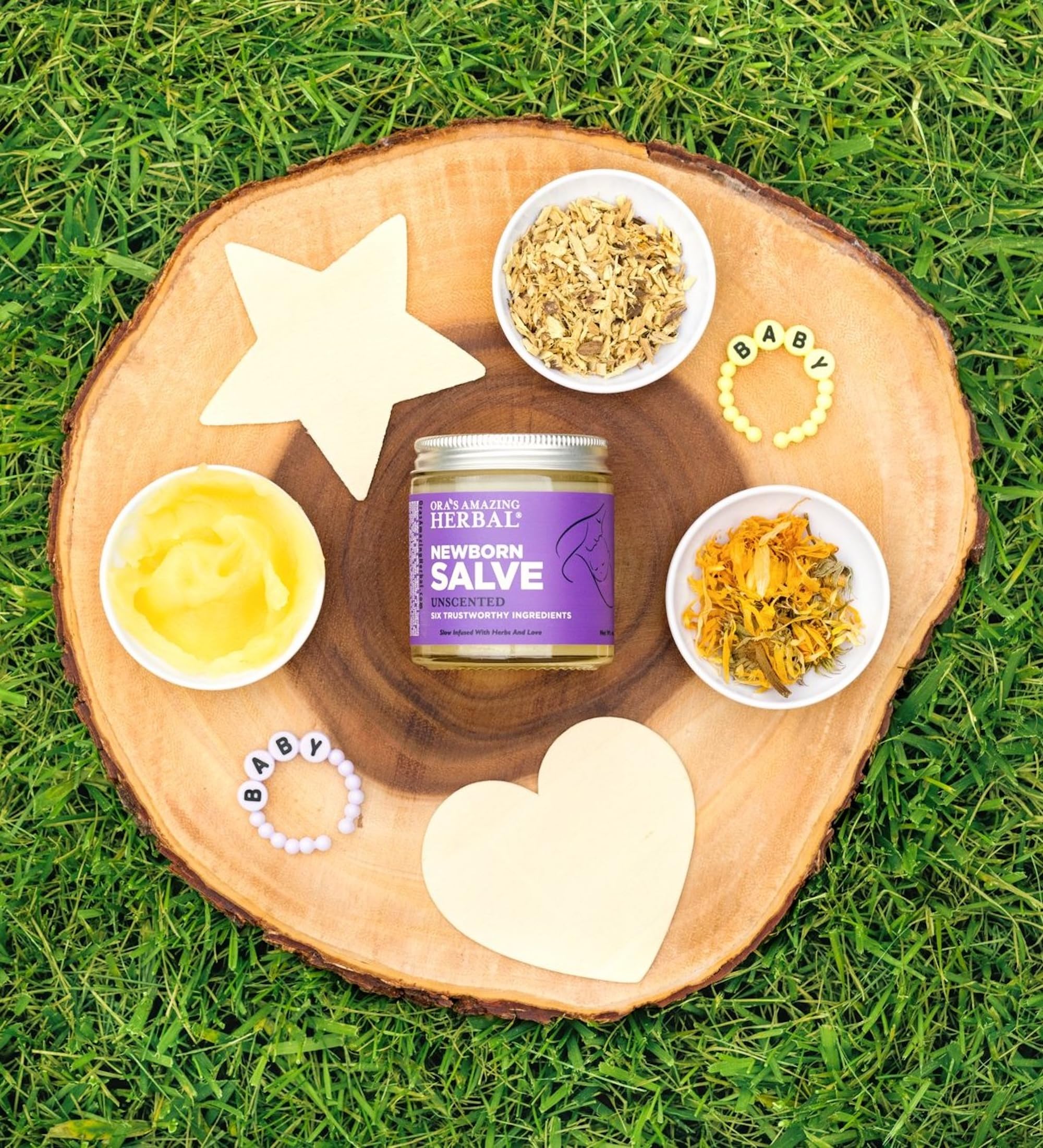 Ora's Amazing Herbal Newborn Salve cradle cap care on baby skin.