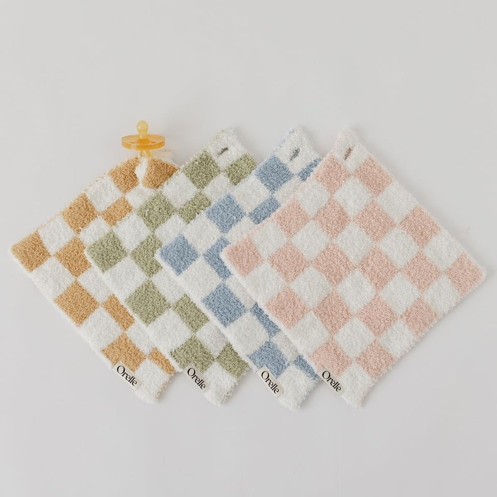 Orelle checkered lovey in nursery scene illustrates gender-neutral decor with functional cuddle buddy