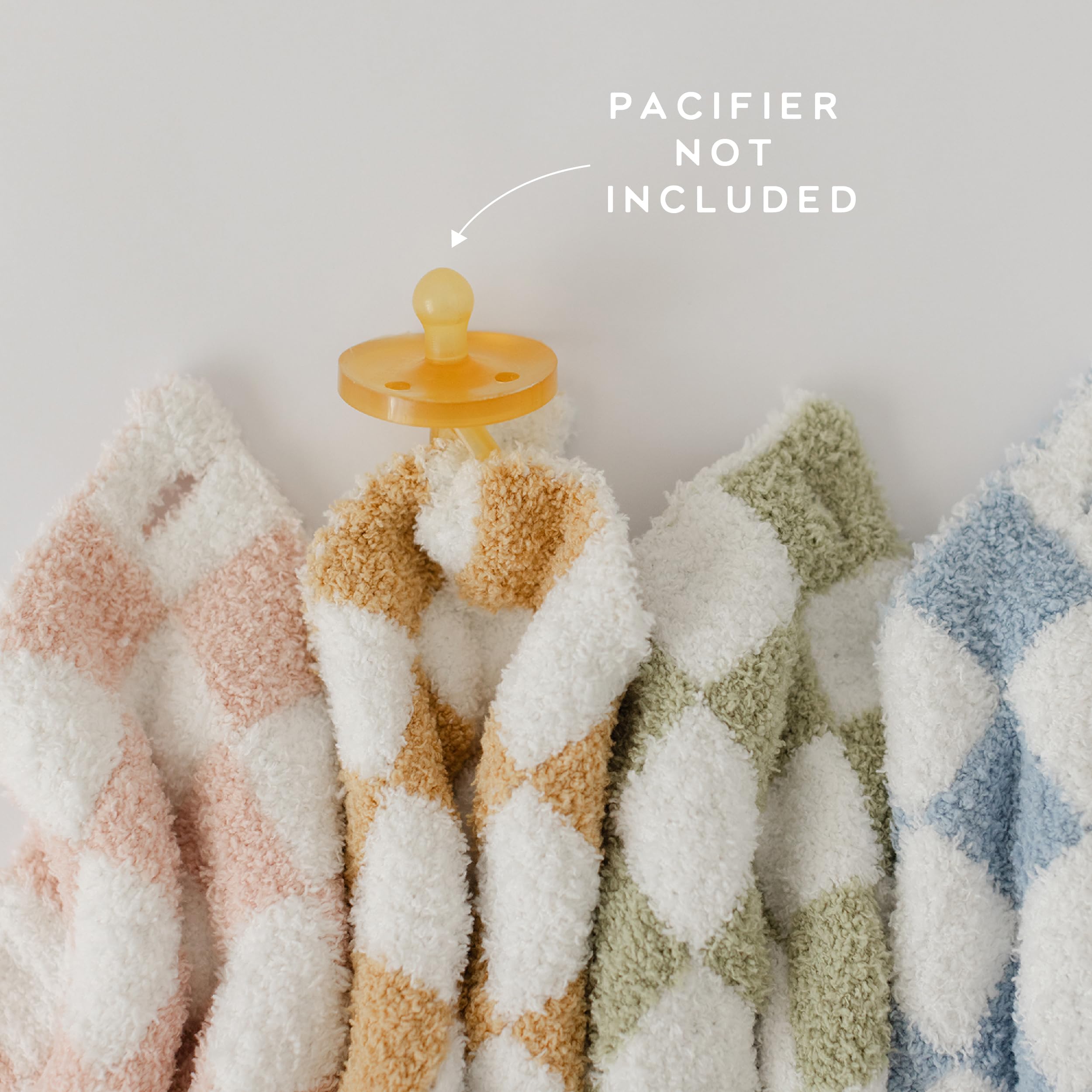 Orelle checkered lovey pacifier attachment demonstrates safe, simple pacifier retention on the go