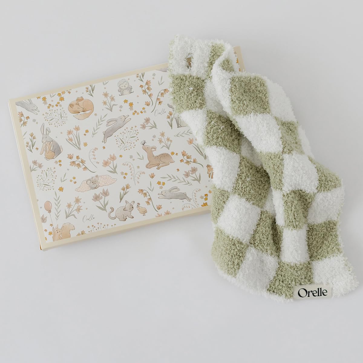 Orelle checkered lovey sage closeup fabric highlights plush texture for soothing baby touch