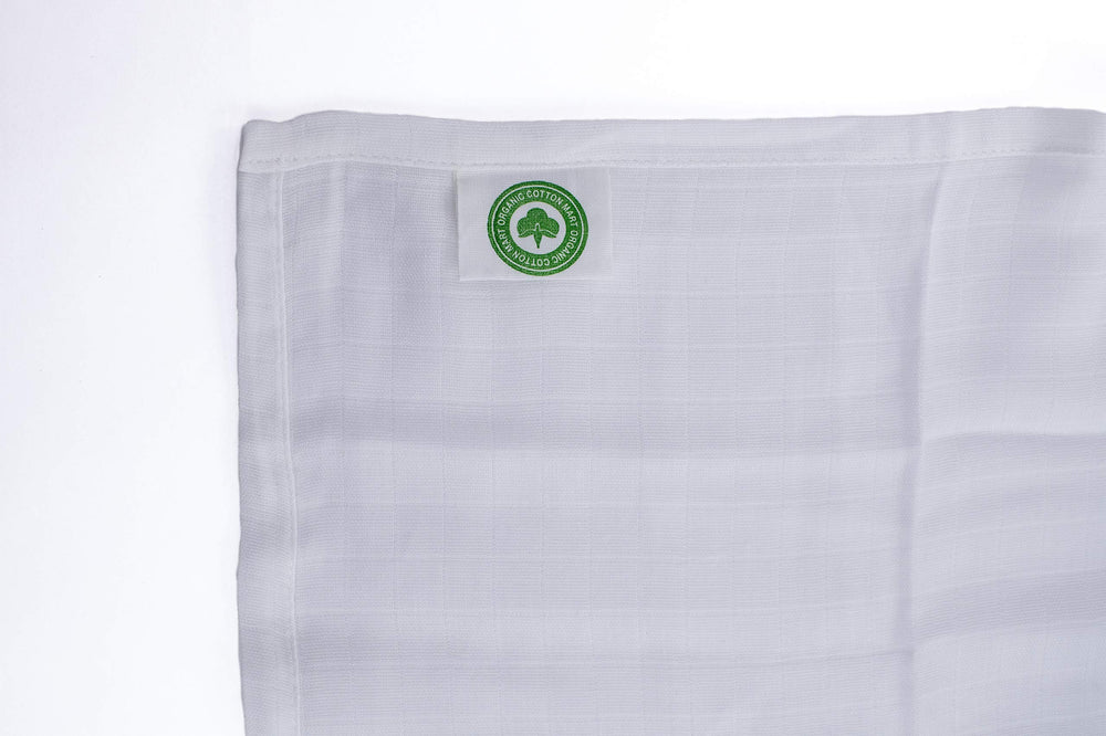 Organic Cotton Mart baby swaddling scene shows gender-neutral design for year-round comfort