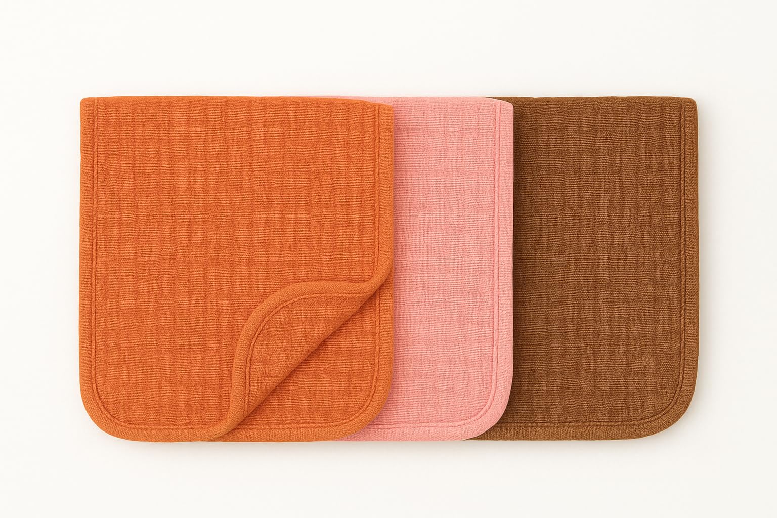 Organic muslin burp cloths 22x10 folded neatly, showcasing generous coverage and soft texture.