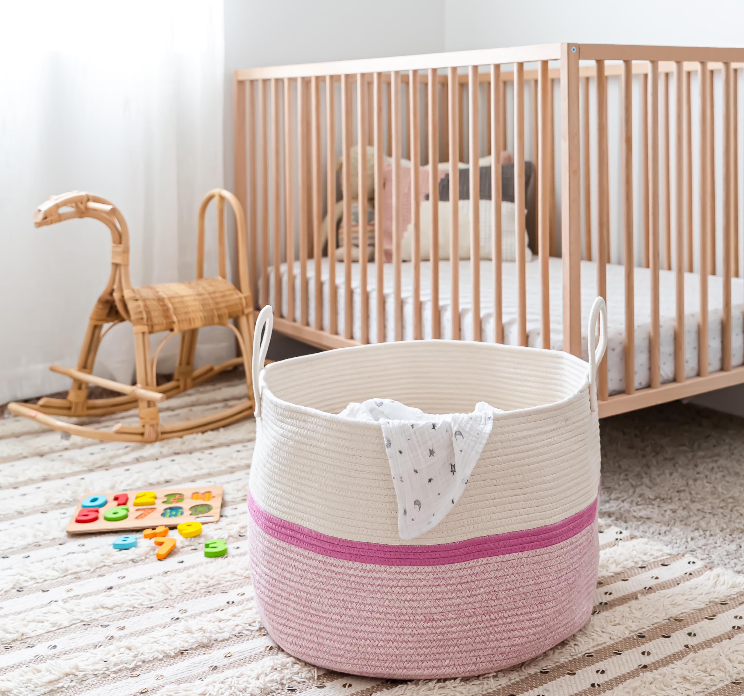 OrganiHaus blanket storage bin showcasing pink stripe weave perfect for living room or bedroom.