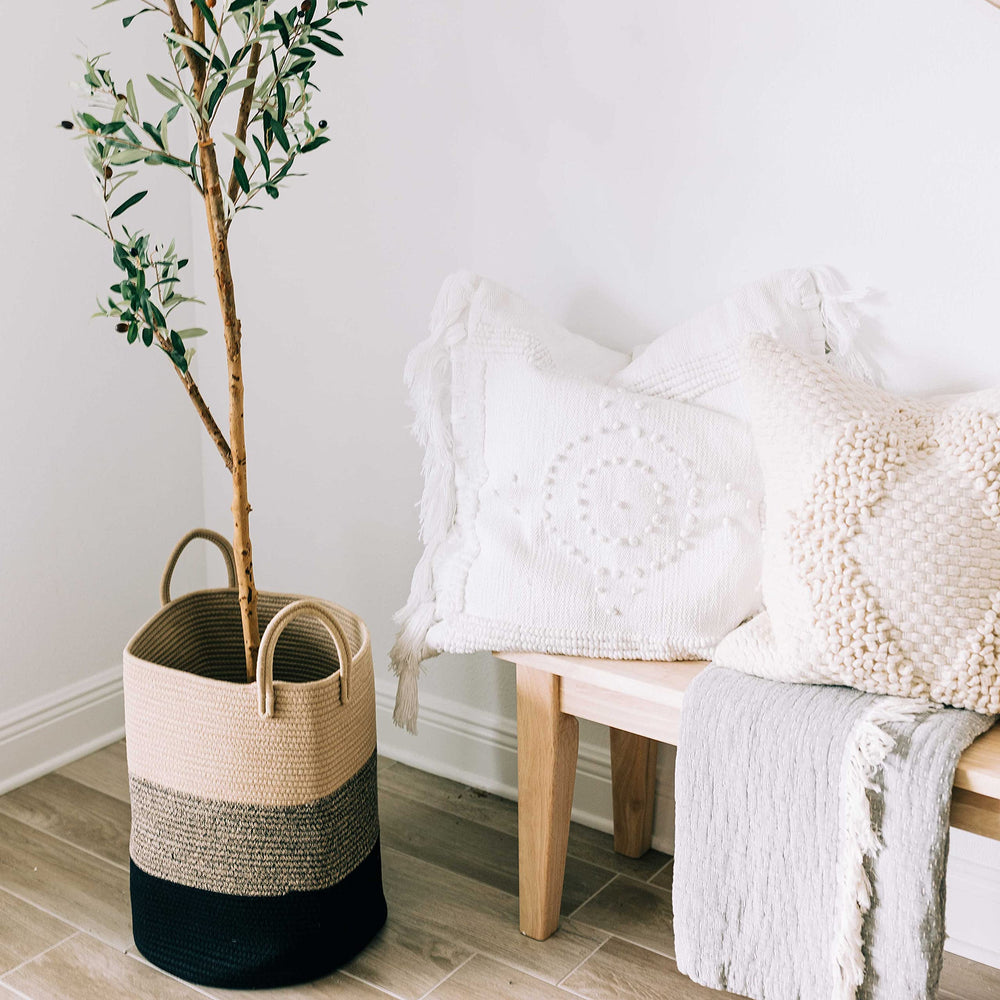 OrganiHaus laundry basket in living room setup blends warm tones with decor.