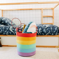 OrganiHaus rainbow woven basket containing blankets for cozy nursery storage.