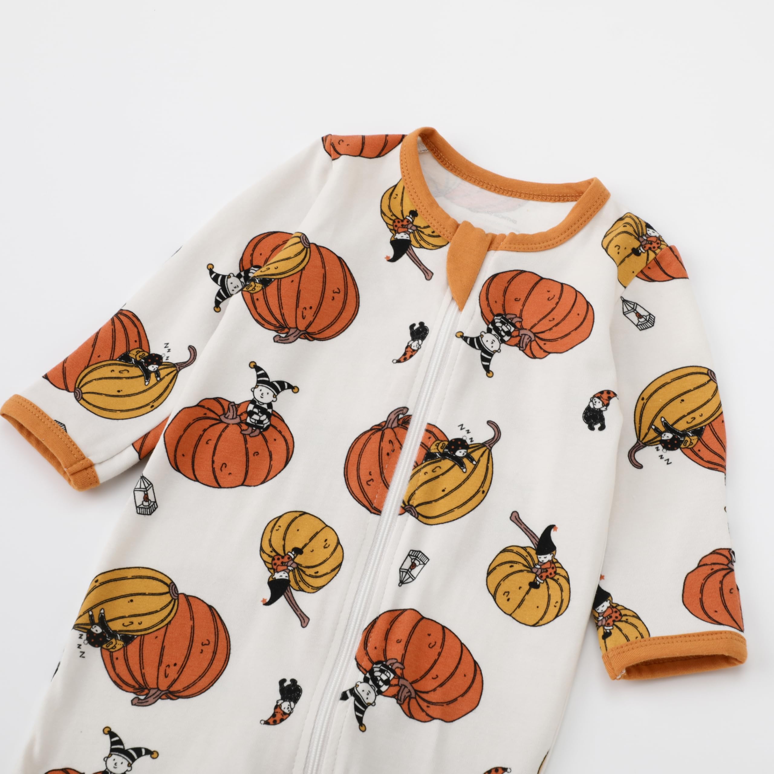Owlivia orange bat pumpkin print pajamas on a baby sleeper.