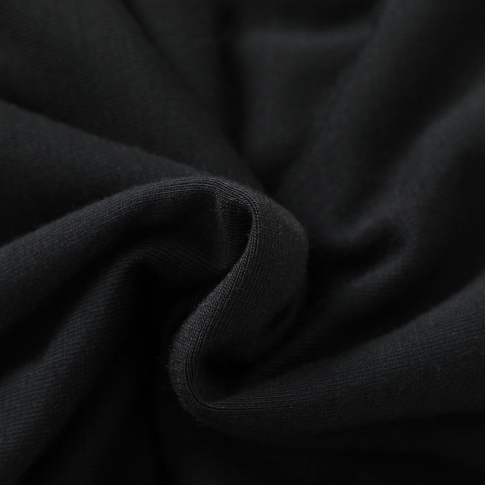 Baby wears Owlivia sleep sack in black during calm bedtime routine.