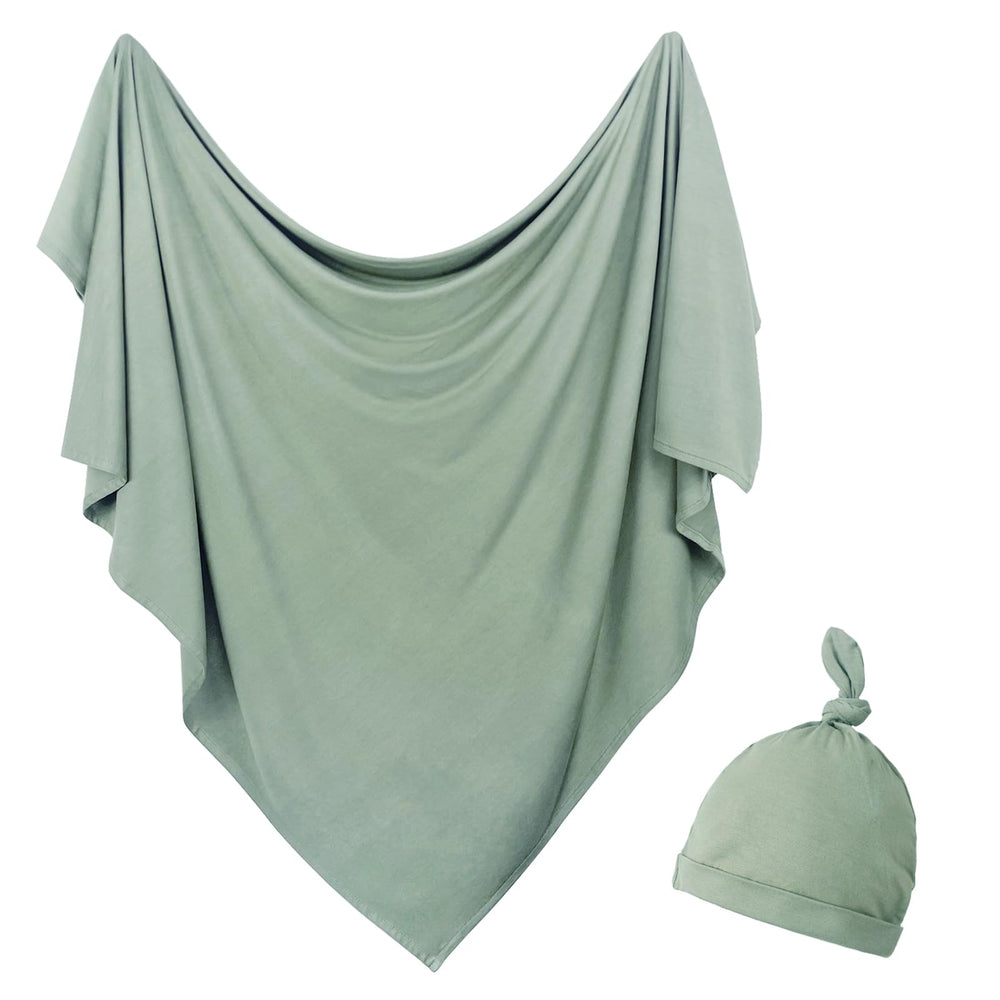 OWLOWLA newborn swaddle olive blanket flatlay shows soft jersey knit for gentle warmth.