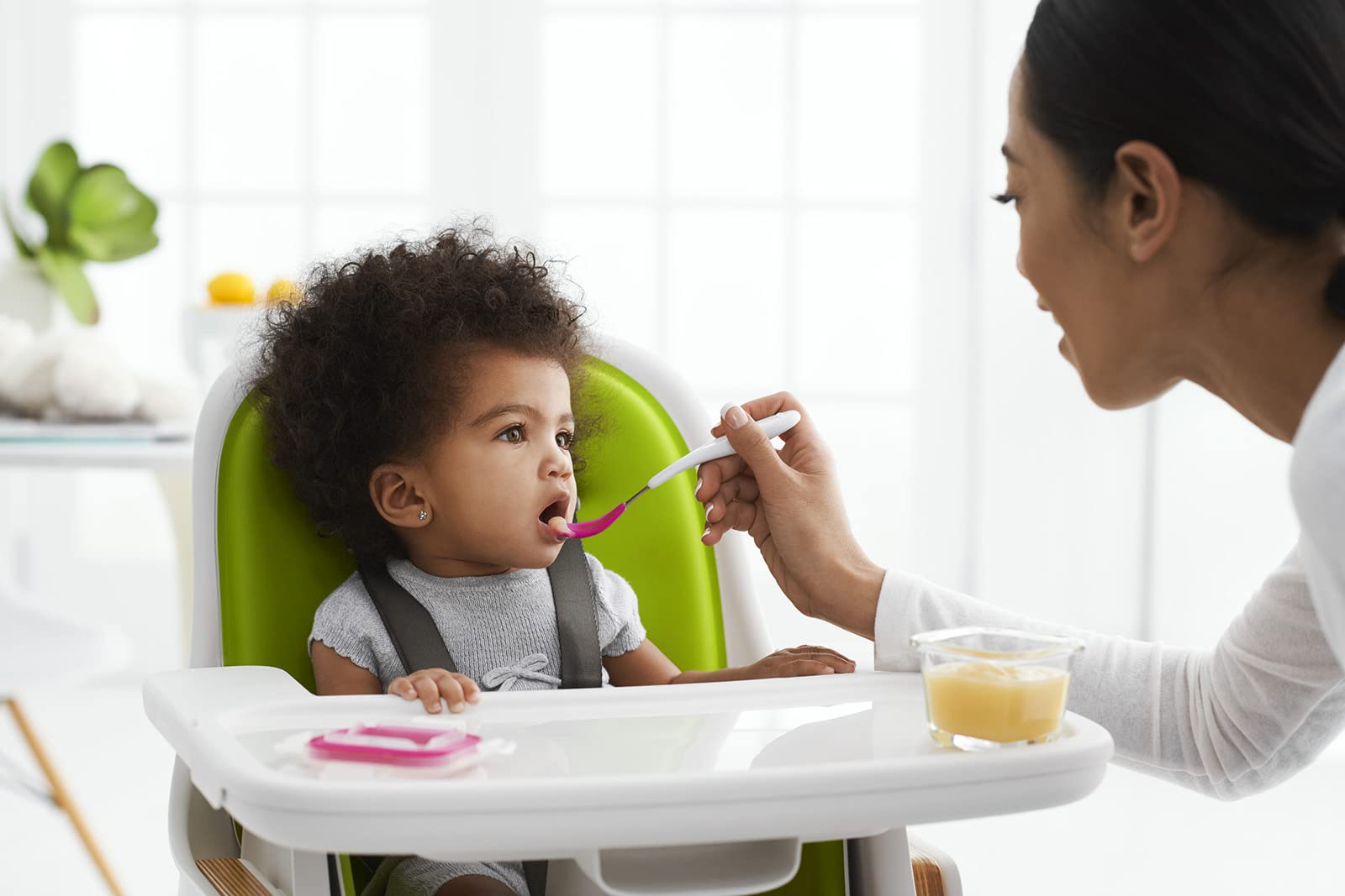 OXO Tot teal spoon designed for easy grip by caregivers
