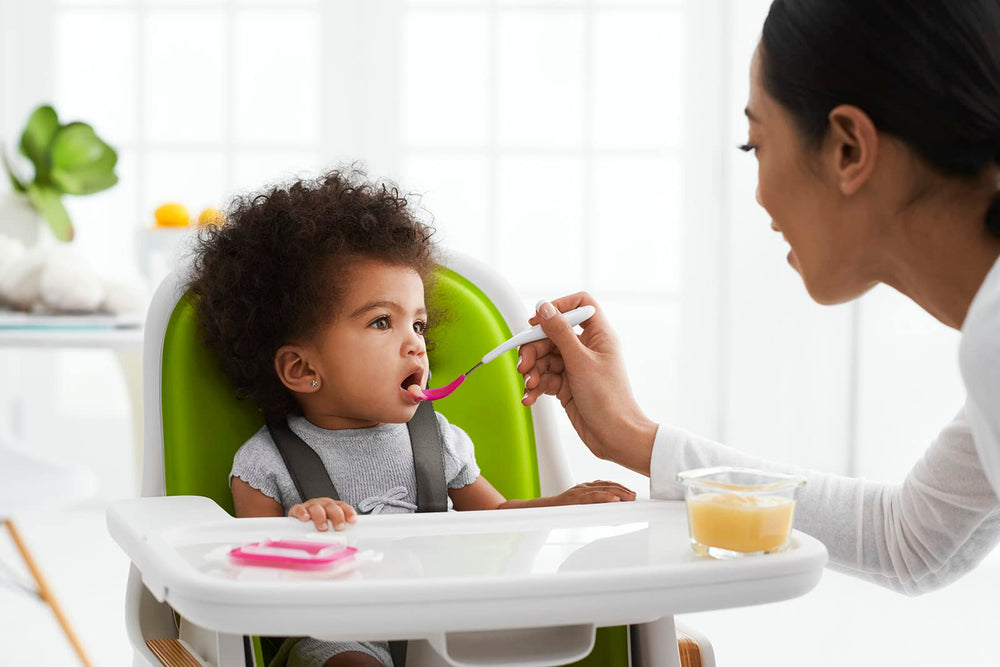 OXO Tot teal spoon designed for easy grip by caregivers