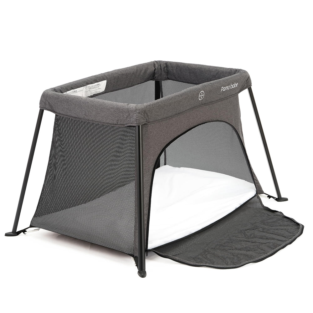 Pamo Babe travel crib room setup featuring a safe play space
