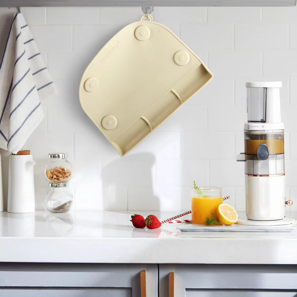 PandaEar placemat with food-catching pocket catching crumbs on table