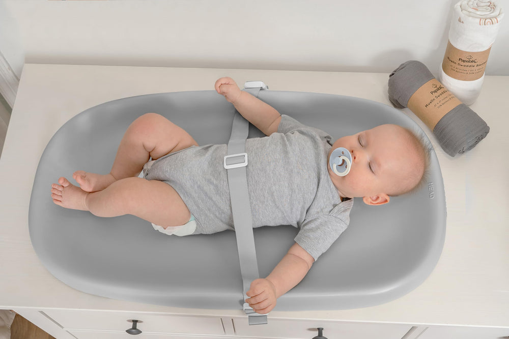 Papablic changing pad slope design to prevent urine pooling and mess spread