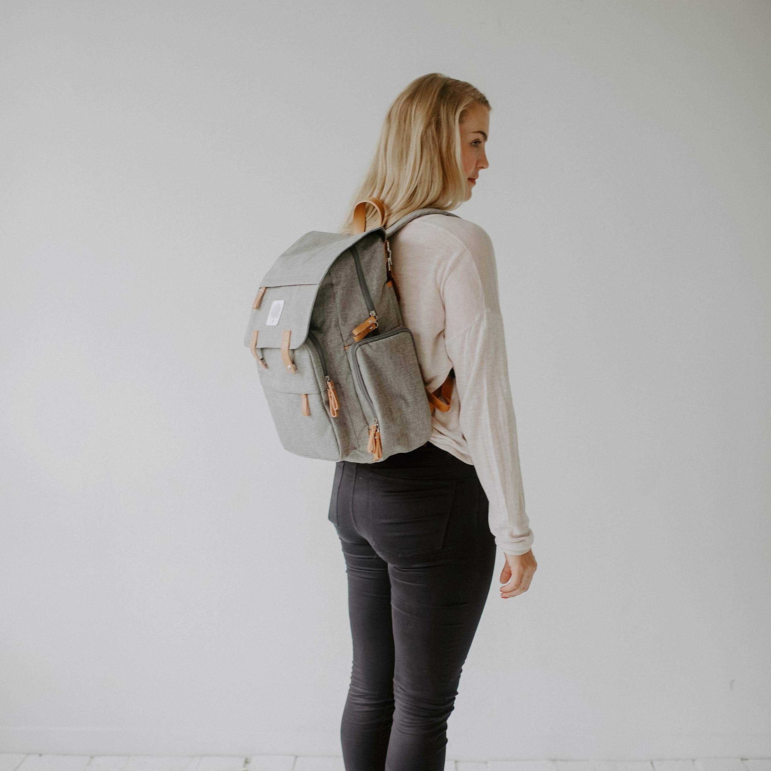 Parker Baby Co. Diaper Backpack wipe-clean changing pad stored in back sleeve.
