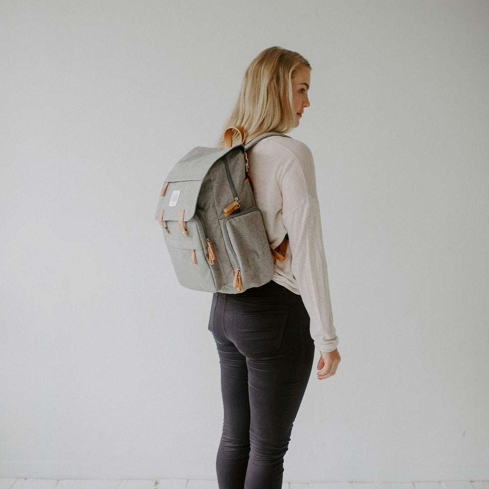 Parker Baby Co. Diaper Backpack wipe-clean changing pad stored in back sleeve.