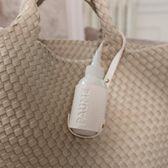 PAUME Voyager Pouch travel bottle slot demonstrates compatibility