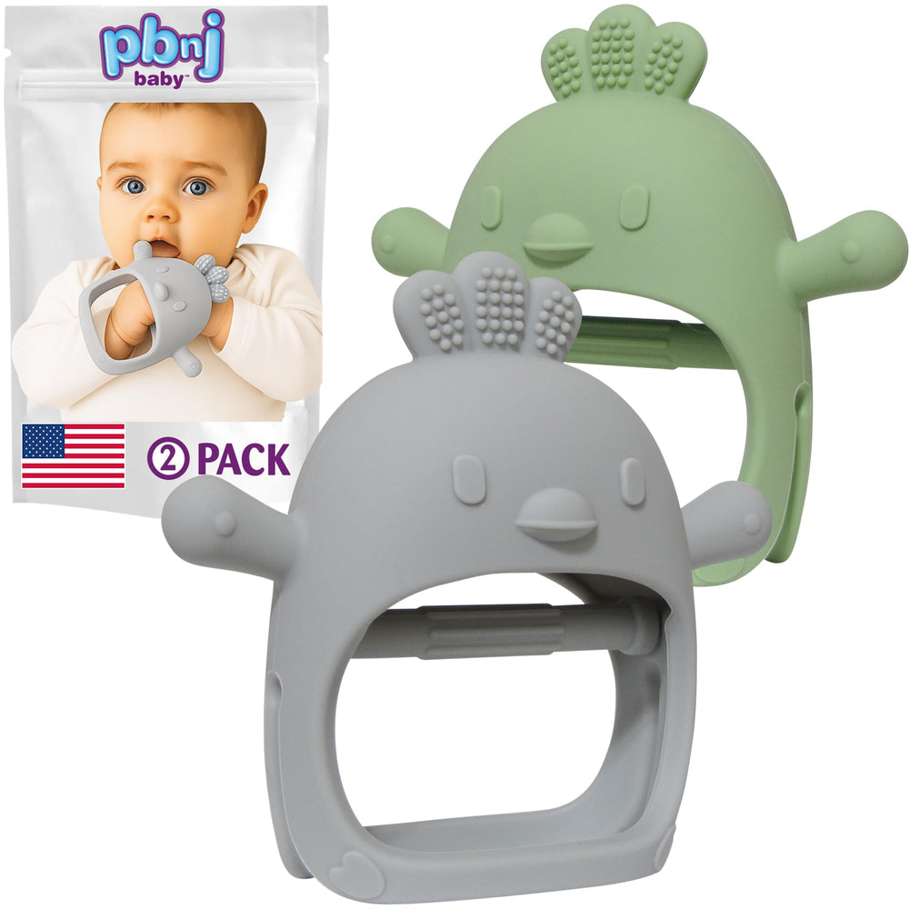 PBnJ Baby silicone teether mitten on tiny hand offers safe teething relief.