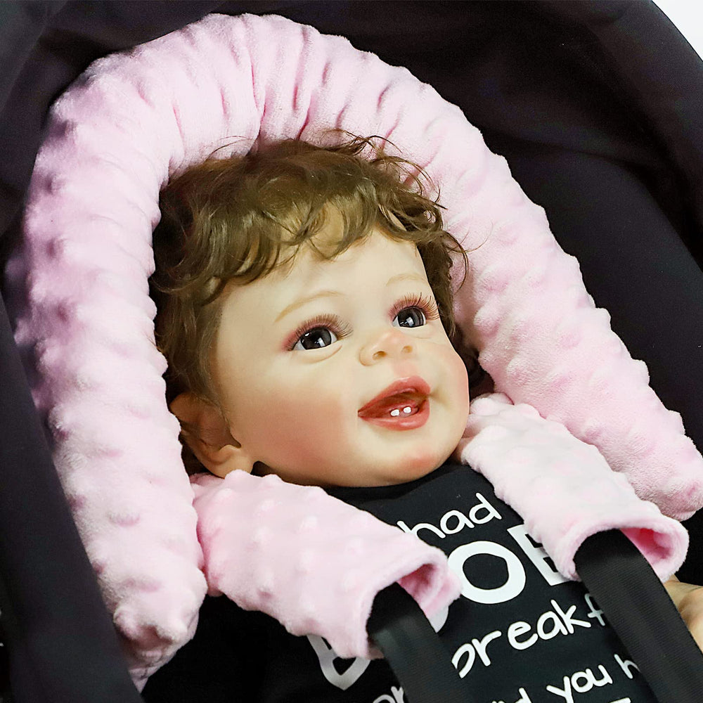 Pea Pod baby in stroller with head and strap coverage for on-the-go comfort.