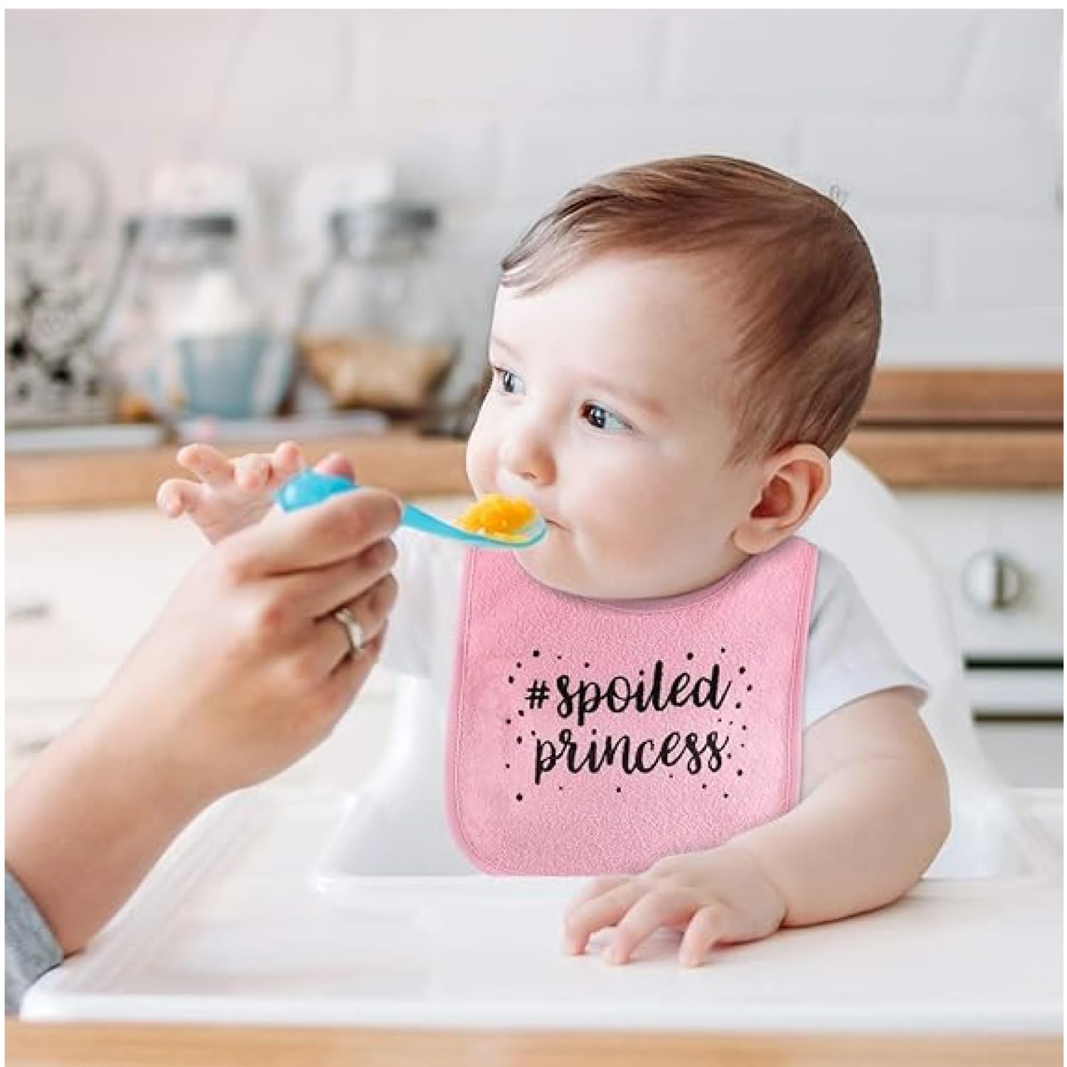 The Peanutshell baby girl pink bibs shown on a baby outfit for drool and meals