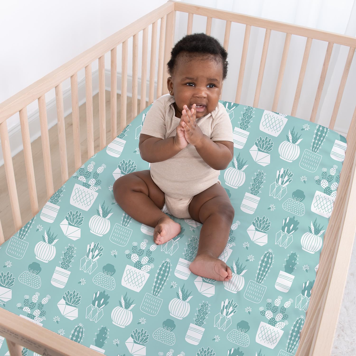 The Peanutshell cactus crib sheet in Pack N Play shows portable crib compatibility.