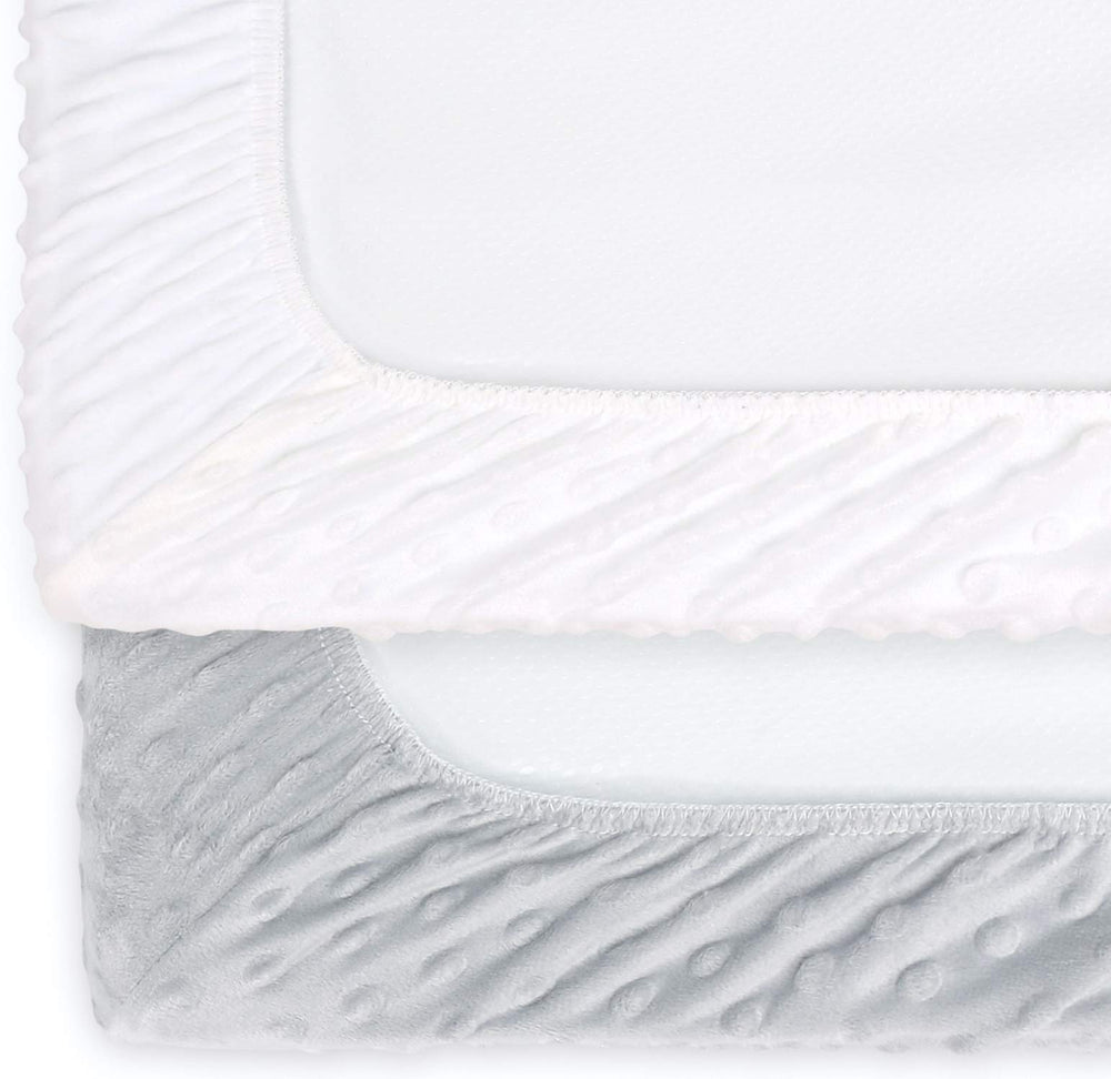 The Peanutshell changing pad cover with center buttonhole showing strap compatibility.