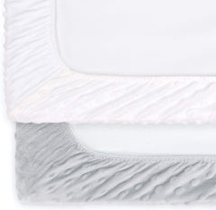 The Peanutshell changing pad cover with center buttonhole showing strap compatibility.