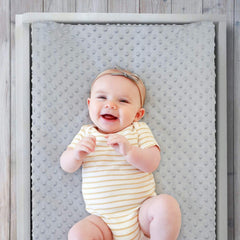 The Peanutshell changing pad cover shown on a standard pad demonstrates secure elastic fit and stay-put design.