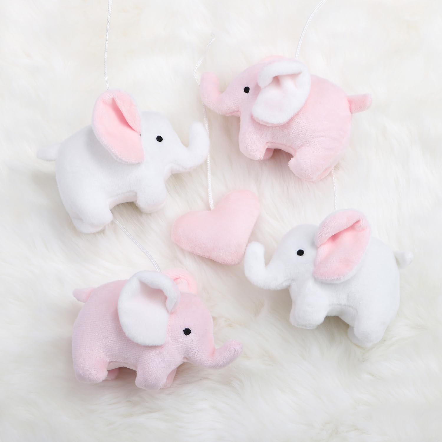 The Peanutshell crib mobile nursery decor adds adorable pink elephant whimsy