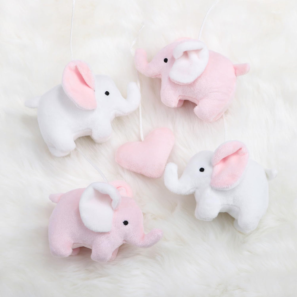 The Peanutshell crib mobile nursery decor adds adorable pink elephant whimsy