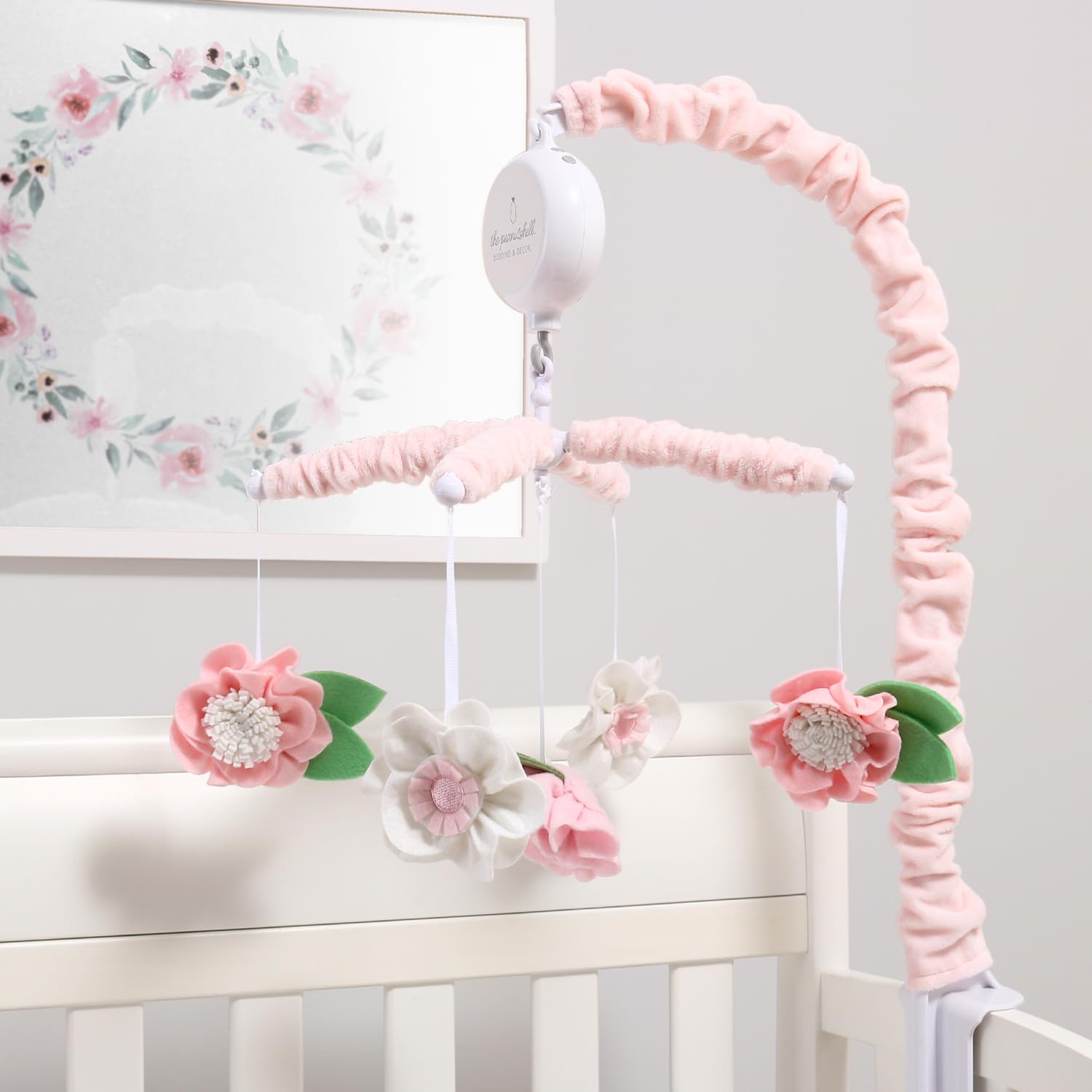 The Peanutshell crib mobile nursery decor adds charming pink florals to any room.