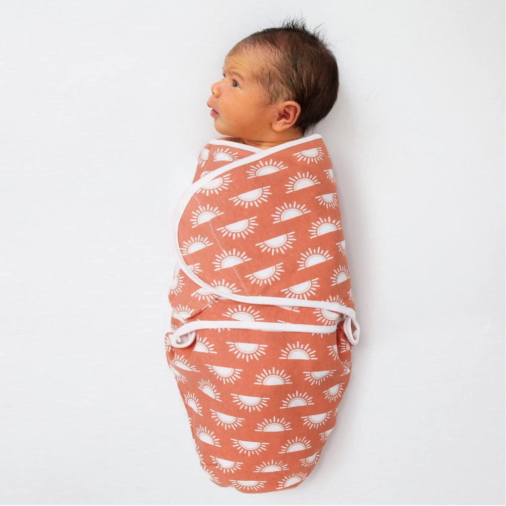 The Peanutshell Desert Safari swaddle on a sleeping baby demonstrates womb-like calm.