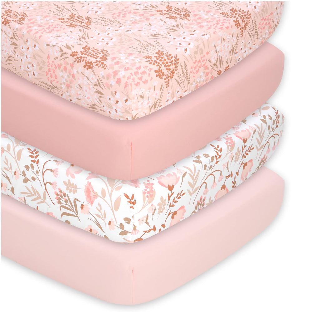 The Peanutshell floral crib sheet set in pink tones adds cohesive nursery decor.