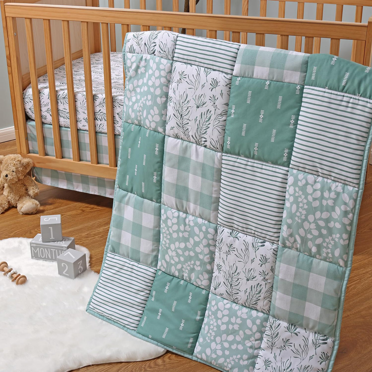 The Peanutshell forest-theme crib quilt adds cozy woodland detail for baby’s nursery.