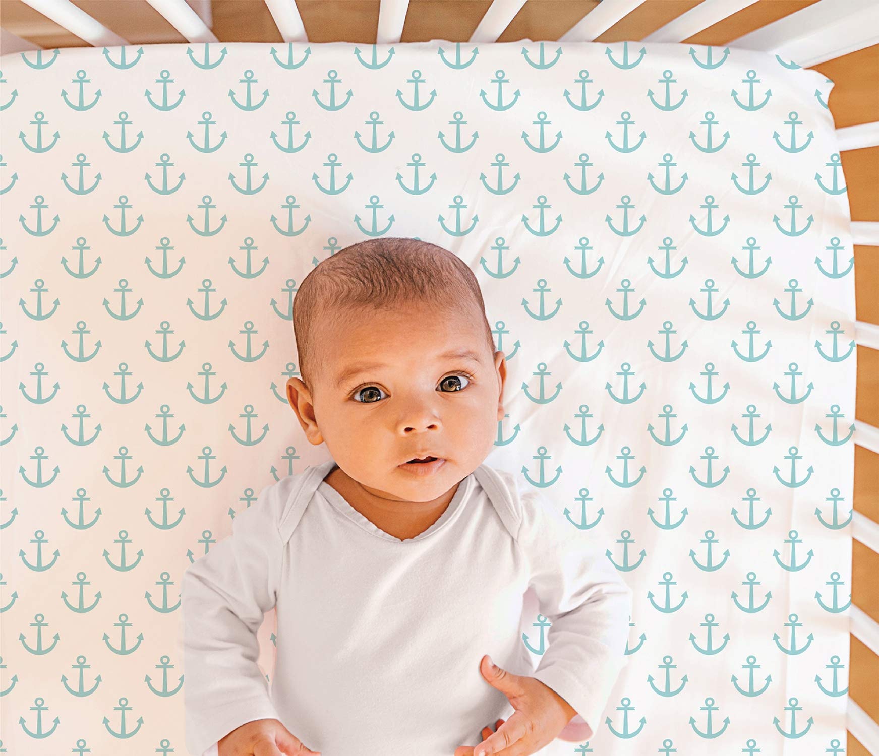 The Peanutshell nautical crib sheet demonstrates secure fit on standard mattresses for peaceful sleep.