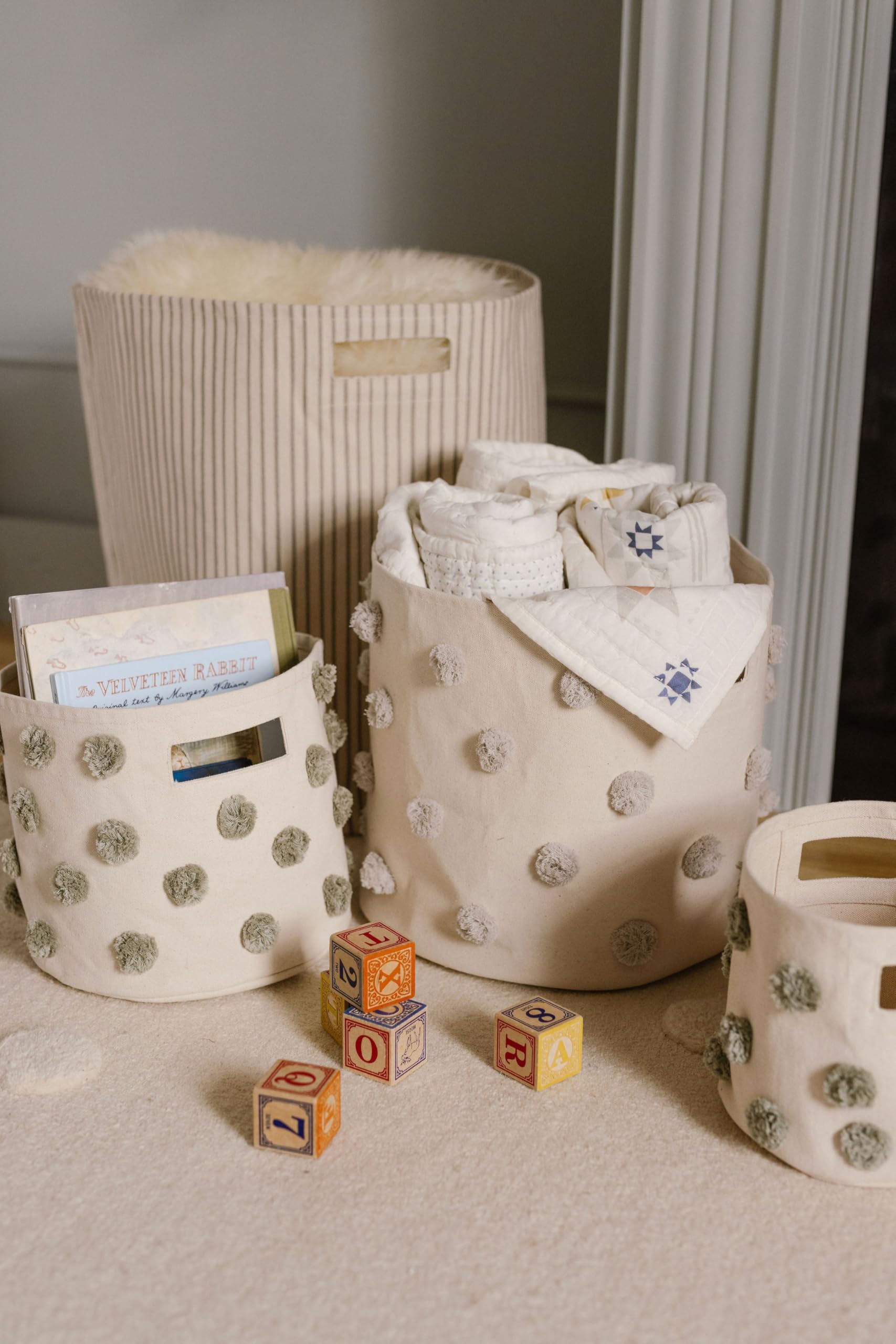 Pehr Pom Pom Basket Grey lifestyle shot demonstrates easy tidying and decorative charm