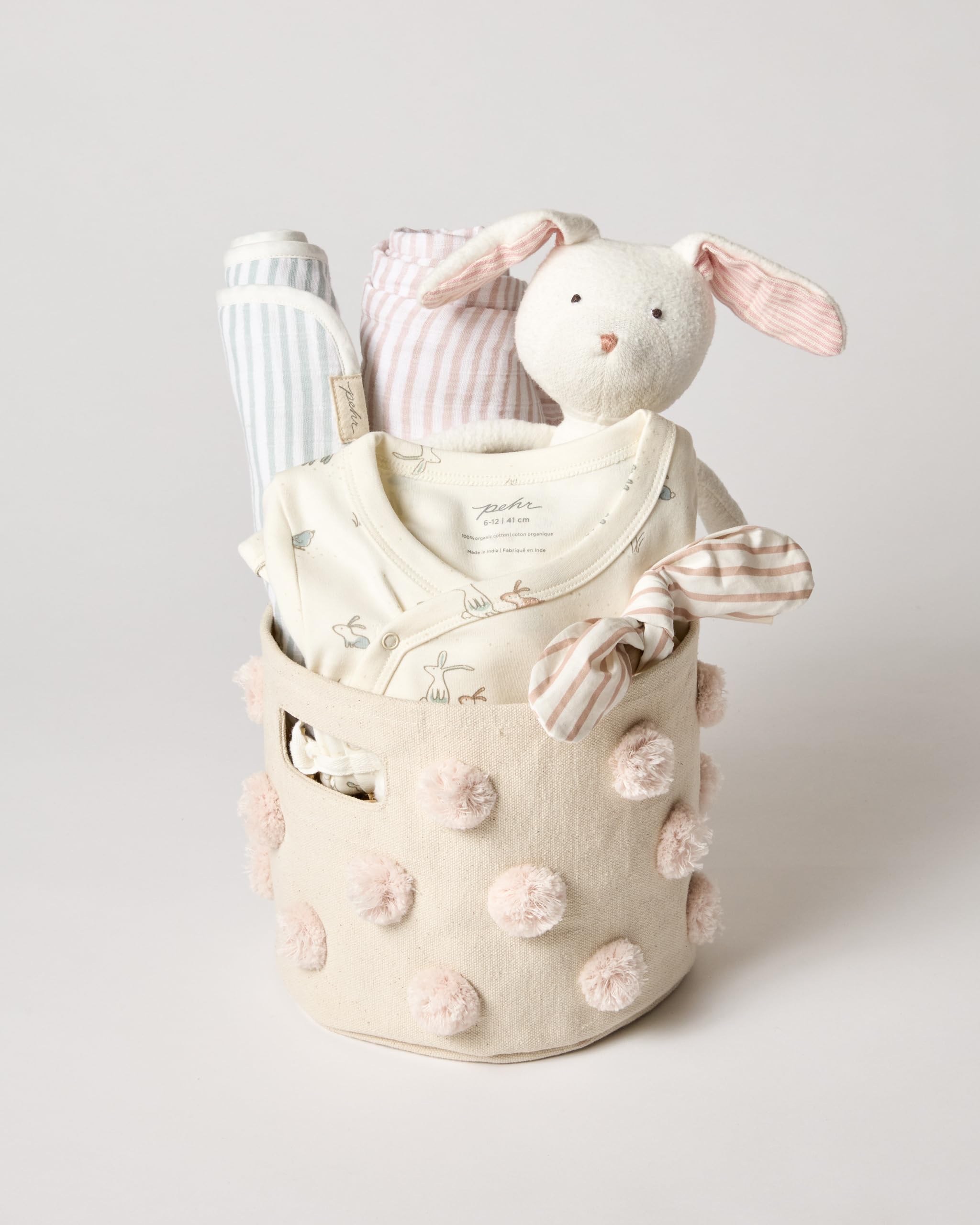 Pehr Pom Pom Basket Mini Blush closeup pom poms add playful decor.