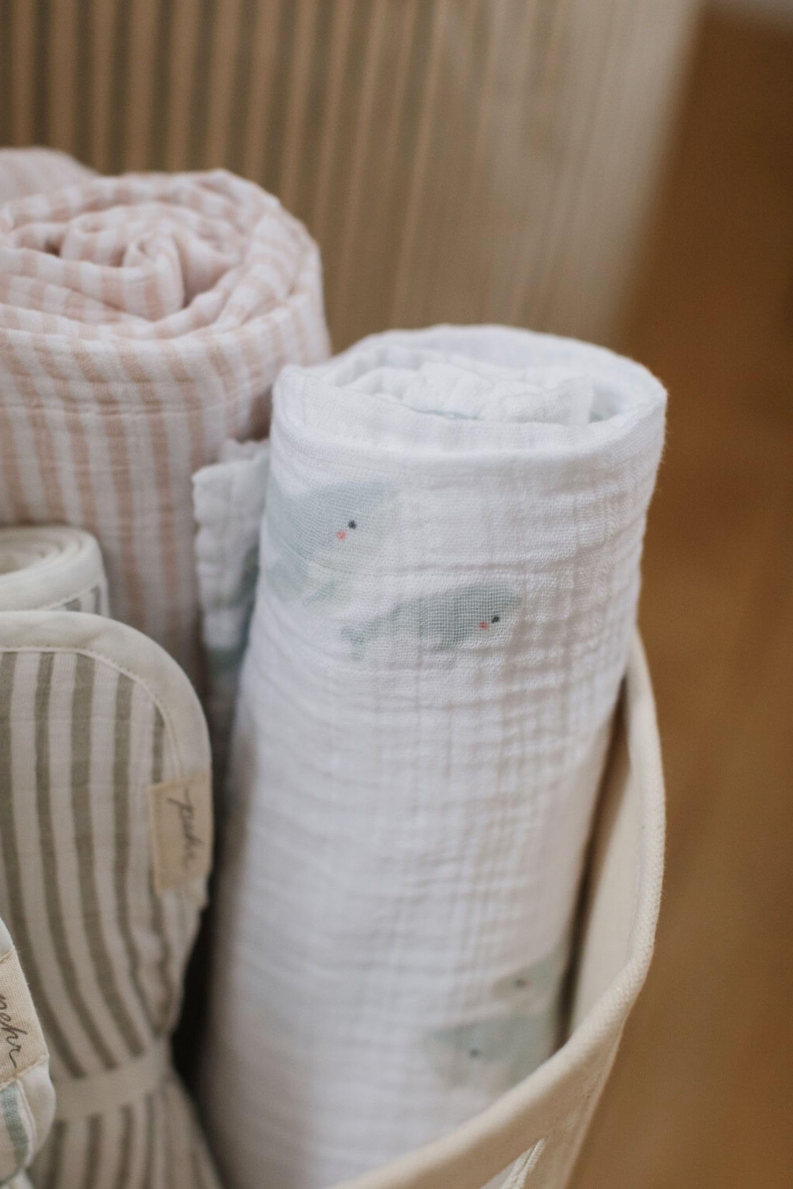 PEHR swaddle used as nursing cover or stroller shade in a calming moment.