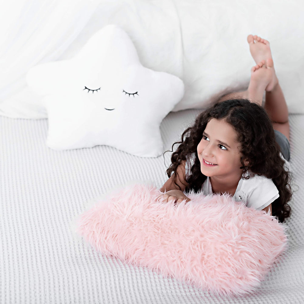 Perfectto Design pillow on bed and reading nook creates a comfy, inviting space.
