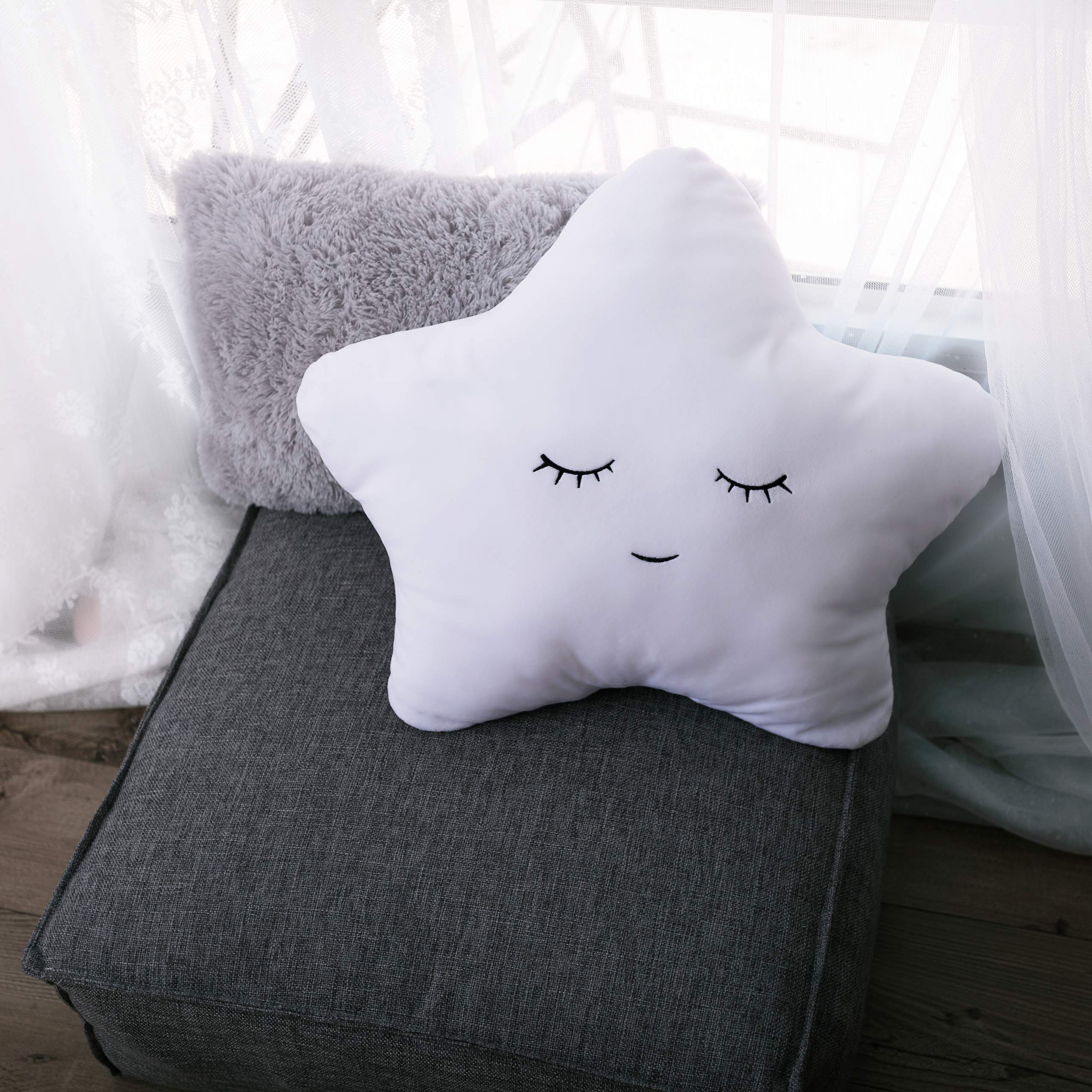 Perfectto Design star pillow on nursery chair adds soft texture for comfy seating.